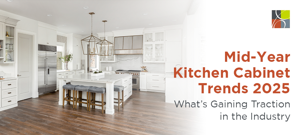 Bright modern kitchen featuring white cabinets, island seating, and warm wood flooring