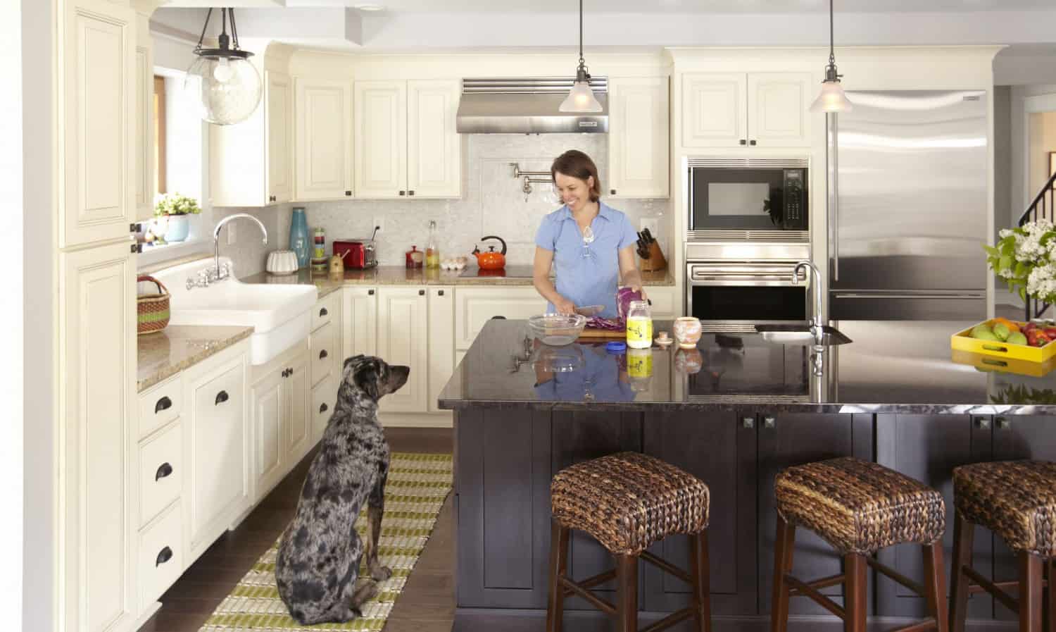 Charcoal gray Shaker-style kitchen cabinets with a white Shaker island 