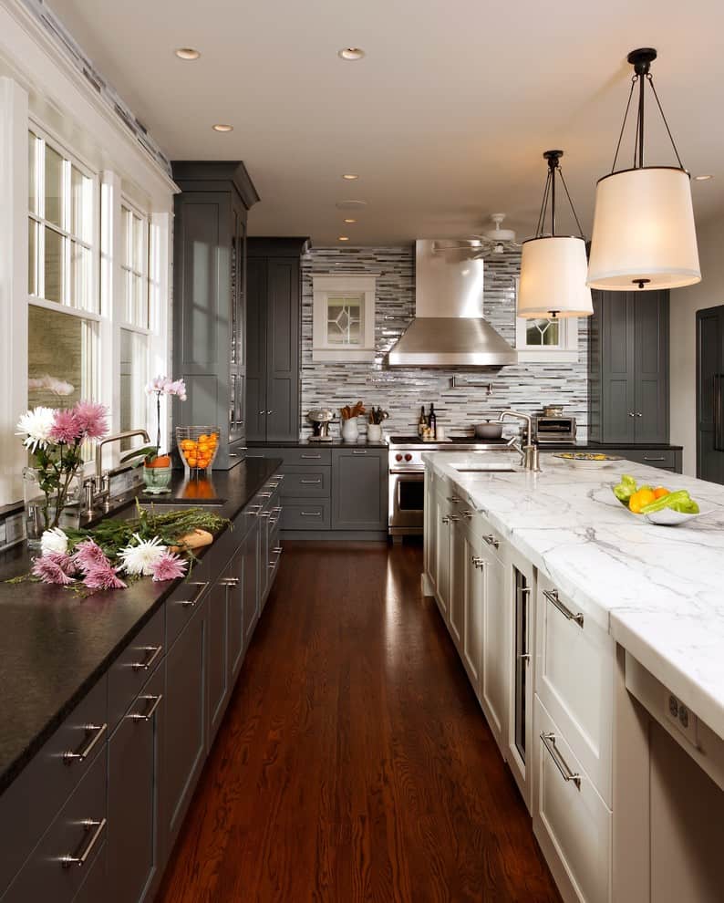 Antique-white Cambridge upper cabinets with a dark gray kitchen island 