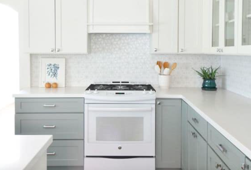 White Shaker-style kitchen cabinets with light gray base cabinets