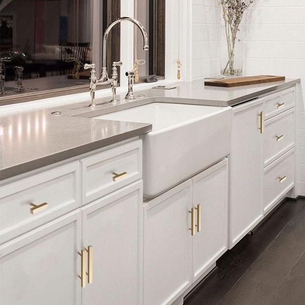 brushed gold hardware with white kitchen cabinets 