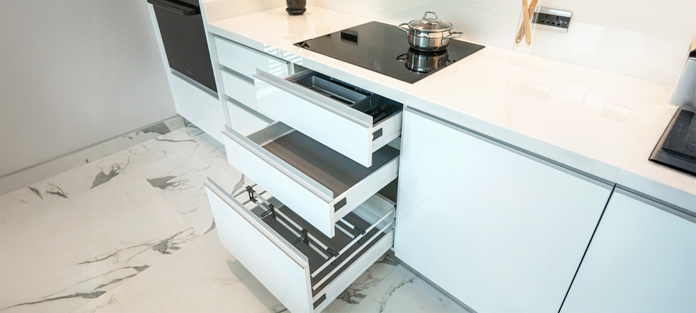Close-up of modern kitchen cabinetry with soft-close drawer system for noise reduction
